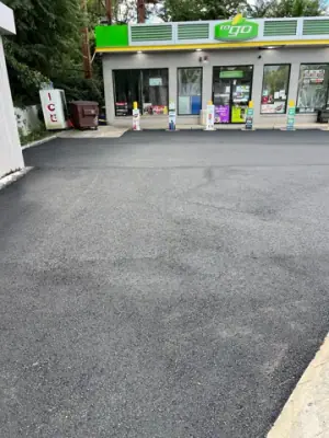 Asphalt forecourt outside the BP station building.