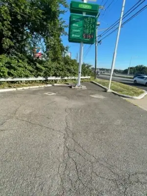Cracked pavement near the roadside BP sign.