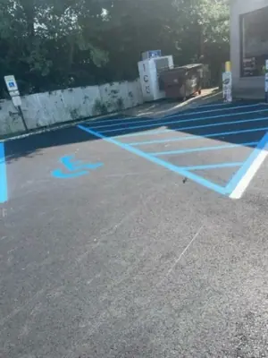 Blue accessible-parking markings and striped access aisle.