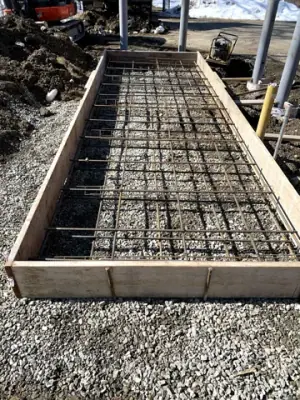 Reinforcing steel and timber forms prepared for the tank foundation.