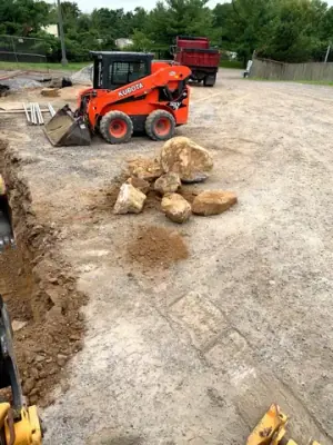 Excavation equipment and exposed ground beside the facility.
