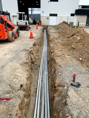 Open utility trench and conduit runs connecting the facility to the fueling area.