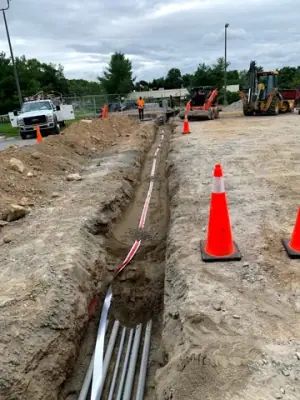 Open utility trench and conduit runs connecting the facility to the fueling area.