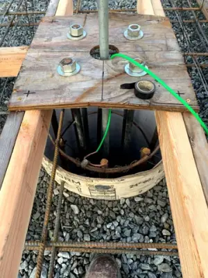 Underground connections inside an open containment chamber.