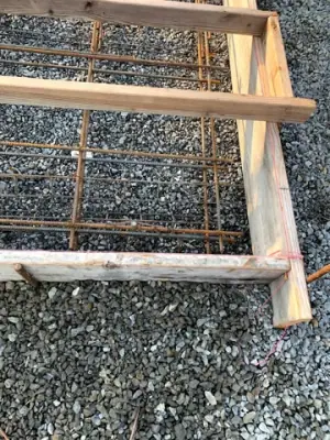 Reinforcement and pipe penetrations within the foundation formwork.