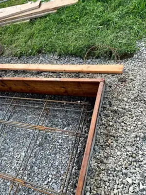 Reinforcing steel and timber forms across the prepared foundation.