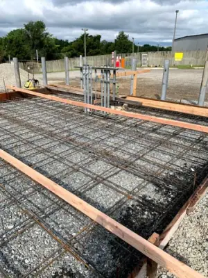Reinforcing steel and timber forms across the prepared foundation.