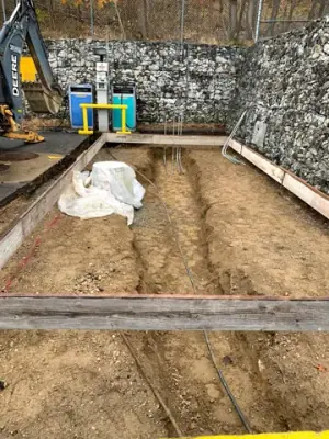 Timber foundation forms around the excavated tank-area services.