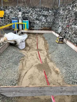 Excavated foundation area with marked service routes.