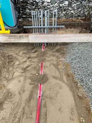 Excavated foundation area with marked service routes.