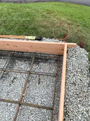 Reinforced concrete formwork over a compacted aggregate base.