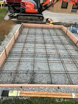 Reinforced concrete formwork over a compacted aggregate base.