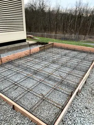 Reinforced concrete formwork over a compacted aggregate base.