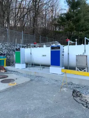 Installed tanks and dispensers along the retaining wall.