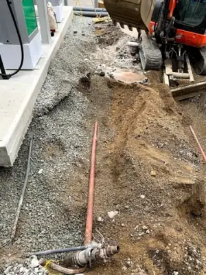 Exposed underground services beside the dispensing equipment.