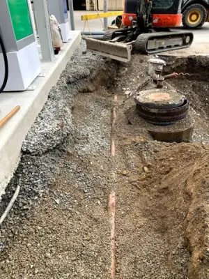 Exposed underground services beside the dispensing equipment.