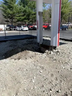Gravel and excavation around a canopy-column base.