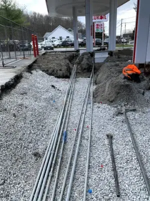 Conduit bends routed from the main trench toward the equipment bases.