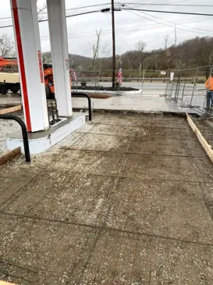Reinforcing mesh and timber forms prepared for a forecourt concrete pour.
