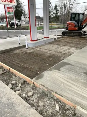 Prepared concrete bays with reinforcement and formwork around the fueling area.