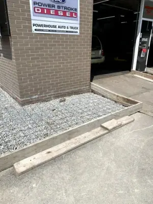 Small formed aggregate pad at a building entrance.