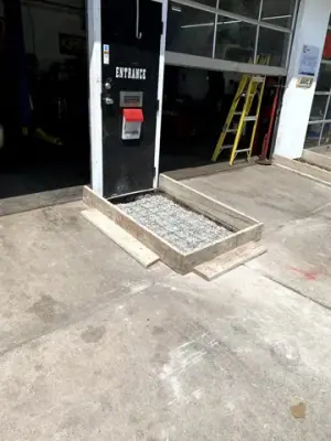Small formed aggregate pad at a building entrance.