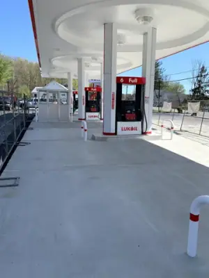 Concrete fueling lanes beneath the station canopy.