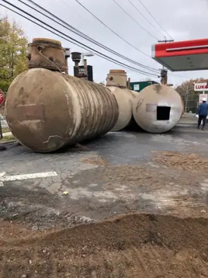 Removed cylindrical tanks staged on the forecourt.