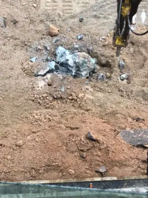 Broken rock exposed in the excavation floor.