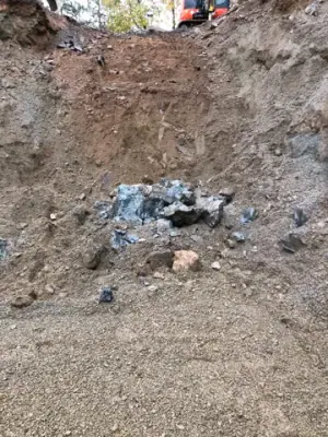 Rock and soil exposed in the wall of the excavation.