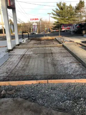 Reinforcing mesh and timber forms prepared for the fueling-lane concrete.