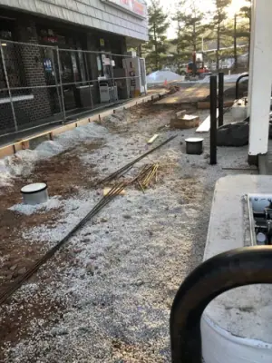 Aggregate and forms along the storefront walkway.