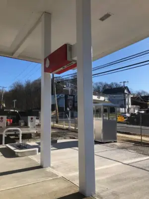Canopy columns and equipment positions above newly finished concrete.