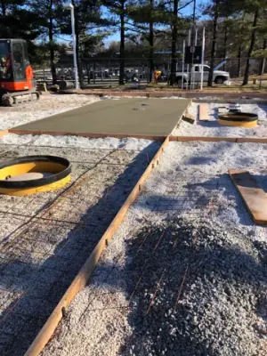 Concrete placement around the tank access openings.