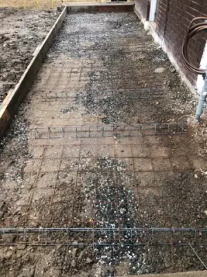 Reinforcing mesh in the prepared building-side sidewalk form.