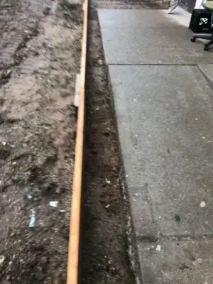 Timber form along the edge of a concrete walkway.